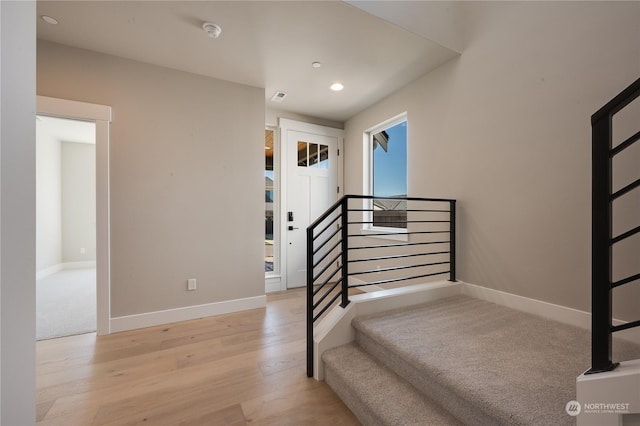 stairs featuring hardwood / wood-style flooring