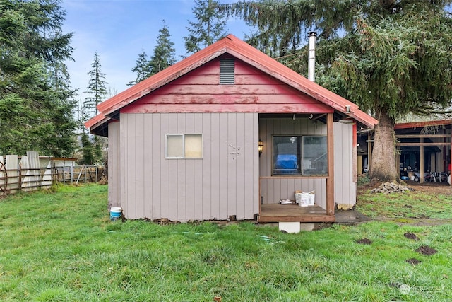 view of outbuilding featuring a lawn