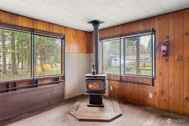 interior space featuring wood walls and a wood stove