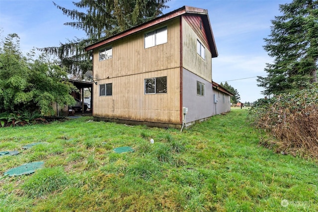 view of side of property with a yard