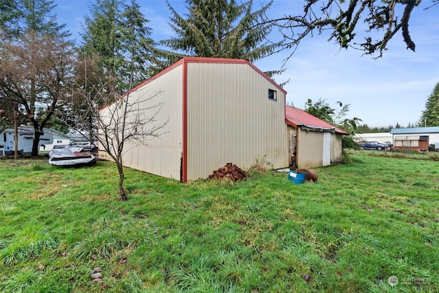 view of outbuilding with a yard