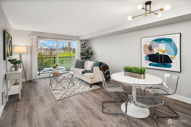 living room featuring a notable chandelier and wood-type flooring