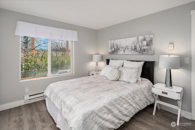 bedroom featuring baseboard heating and dark wood-type flooring