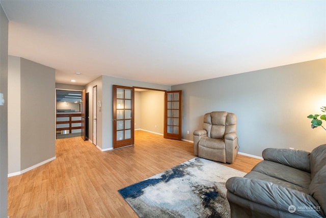 living room with light wood-type flooring and french doors