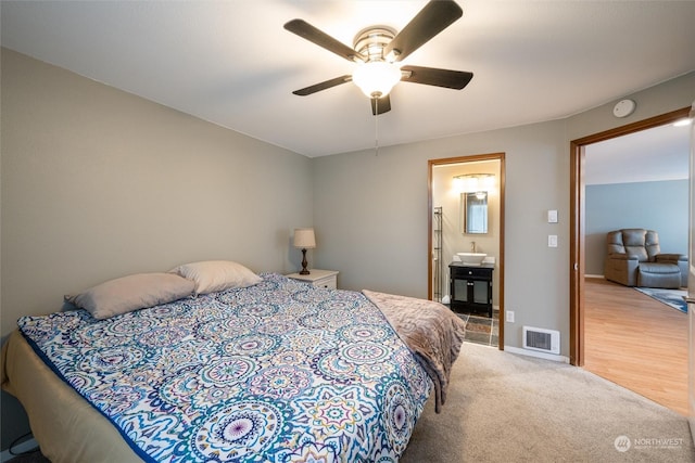 carpeted bedroom featuring ceiling fan, sink, and connected bathroom