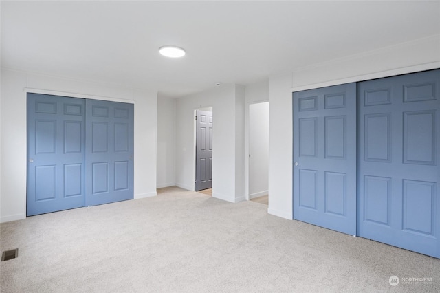 unfurnished bedroom featuring light colored carpet