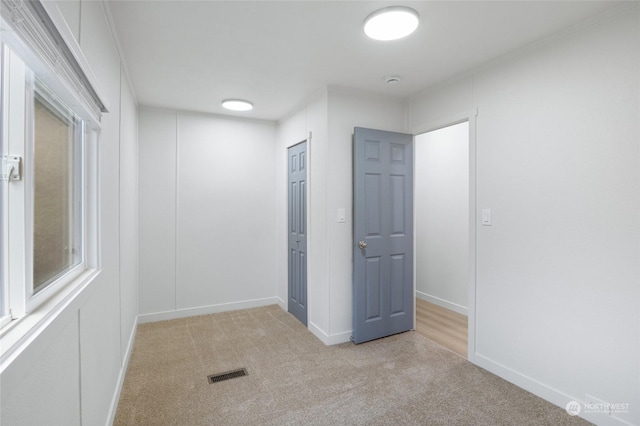 carpeted spare room with a wealth of natural light