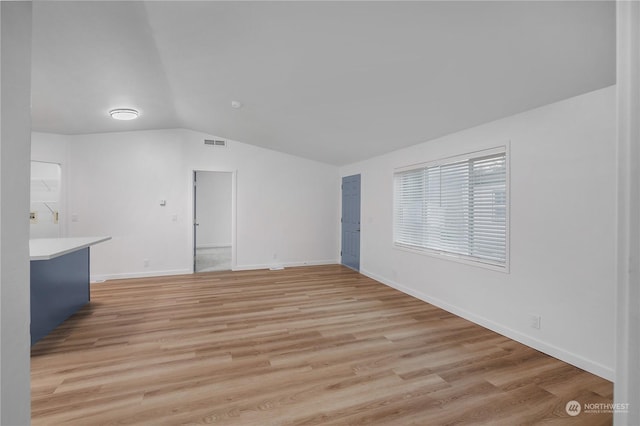 interior space with lofted ceiling and light wood-type flooring