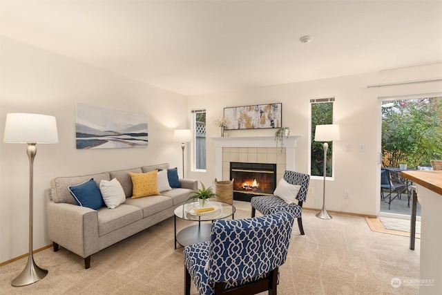 living room featuring a tiled fireplace and carpet floors