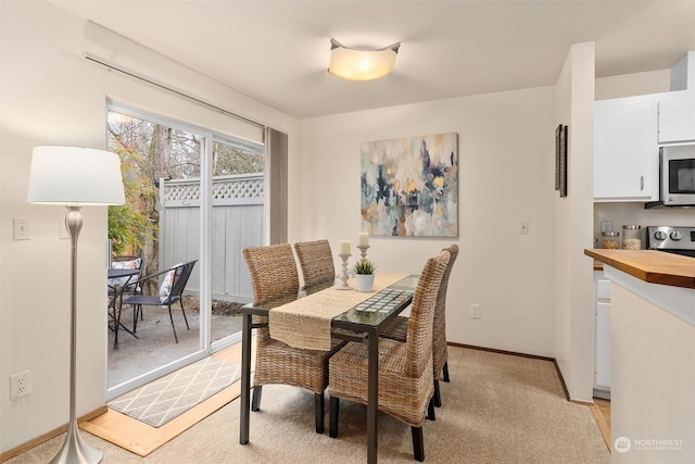 dining area with light colored carpet