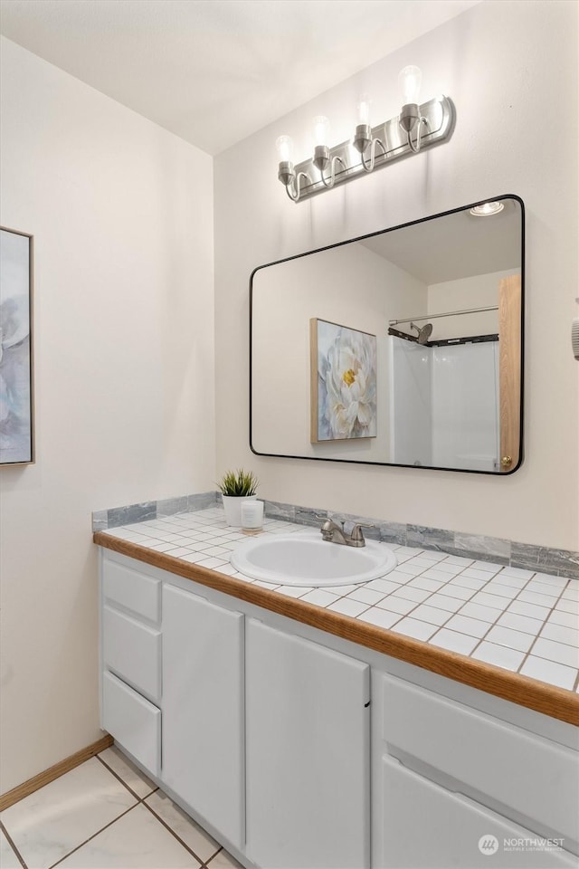 bathroom featuring tile patterned flooring and vanity