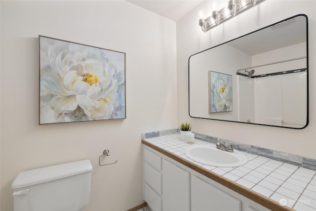 bathroom with a shower, vanity, and toilet