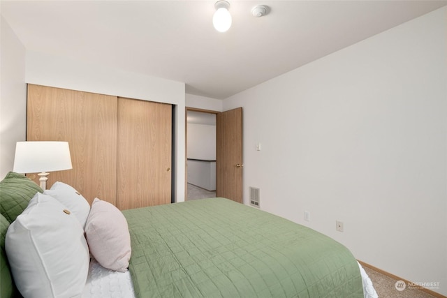 carpeted bedroom featuring a closet