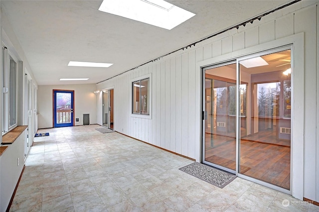 interior space with a skylight, visible vents, and a textured ceiling