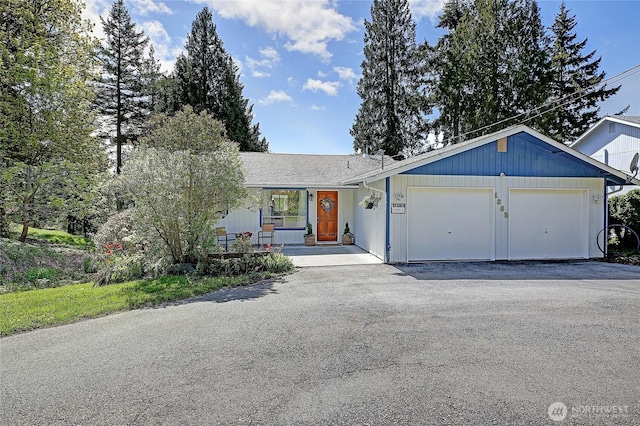 ranch-style home with driveway and a garage