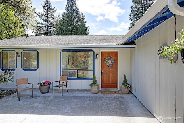 entrance to property with roof with shingles