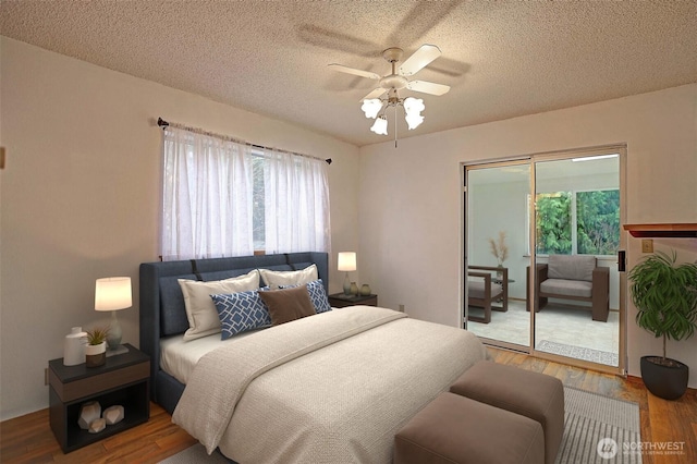 bedroom featuring a ceiling fan, wood finished floors, and a textured ceiling