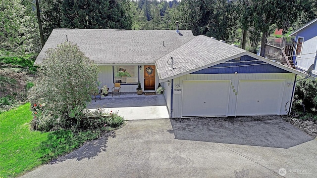 ranch-style house with an attached garage, driveway, a porch, and roof with shingles
