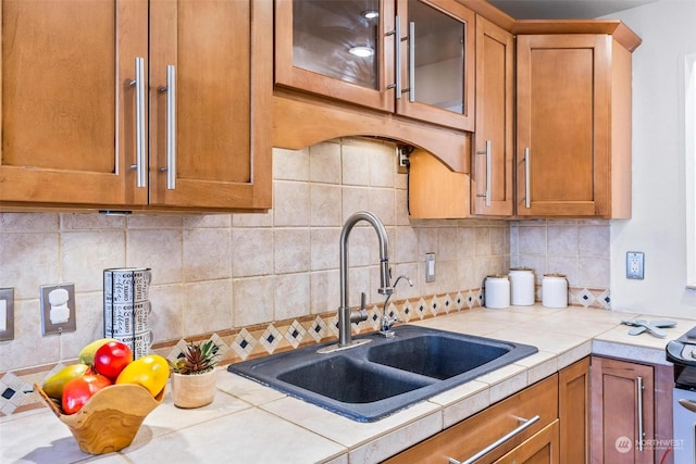 kitchen with sink, decorative backsplash, and tile countertops