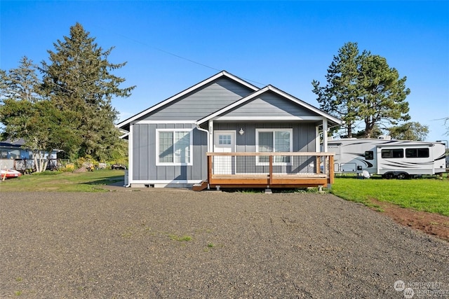 view of front of house with a front lawn and a wooden deck