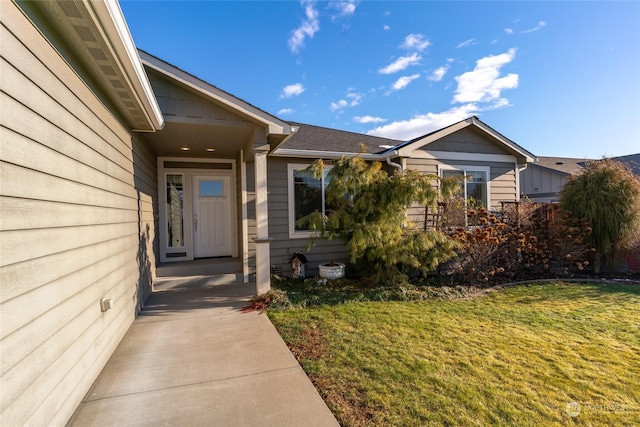 property entrance featuring a lawn