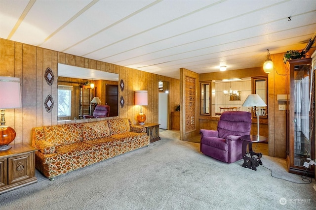 carpeted living room with an inviting chandelier and wooden walls