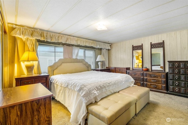 carpeted bedroom with wooden walls