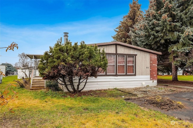 view of side of property with a yard