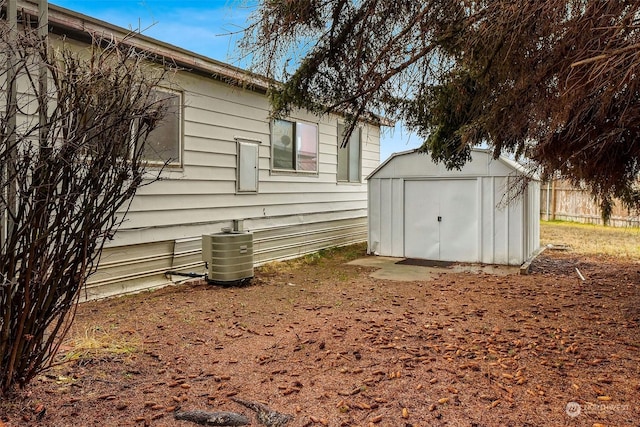 exterior space featuring central AC unit and a storage unit