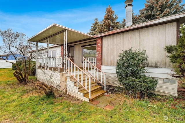 view of exterior entry with covered porch