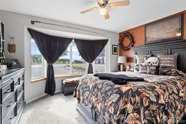 bedroom featuring light colored carpet and ceiling fan