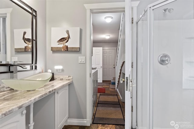 bathroom featuring vanity and an enclosed shower