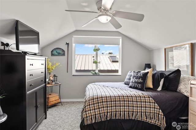 carpeted bedroom with vaulted ceiling and ceiling fan