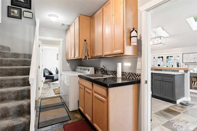 laundry area featuring cabinets and sink