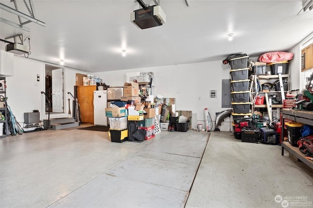 garage with electric panel and a garage door opener