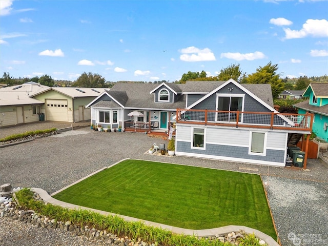 view of front of home featuring a garage, a wooden deck, and a front lawn