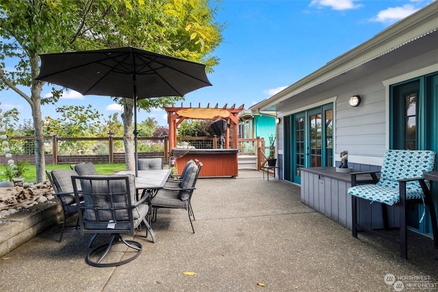 view of patio / terrace with a pergola and a hot tub