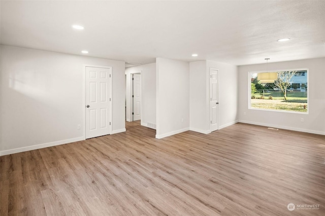 spare room featuring light hardwood / wood-style floors