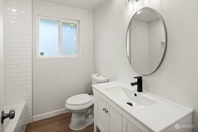 full bathroom with wood-type flooring, vanity, shower / bathtub combination, and toilet