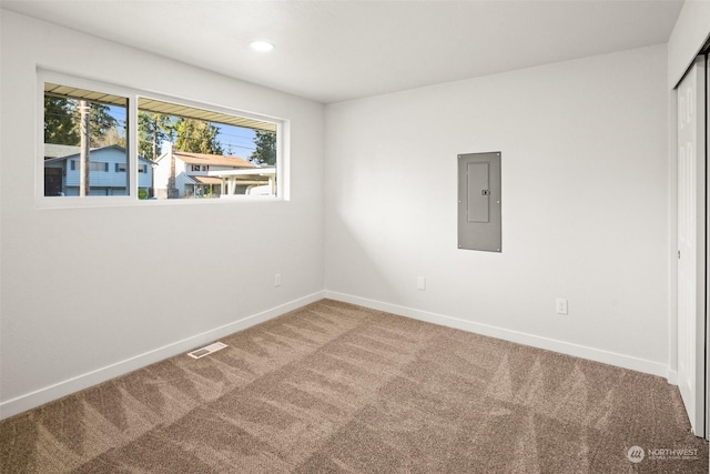 empty room featuring carpet flooring and electric panel