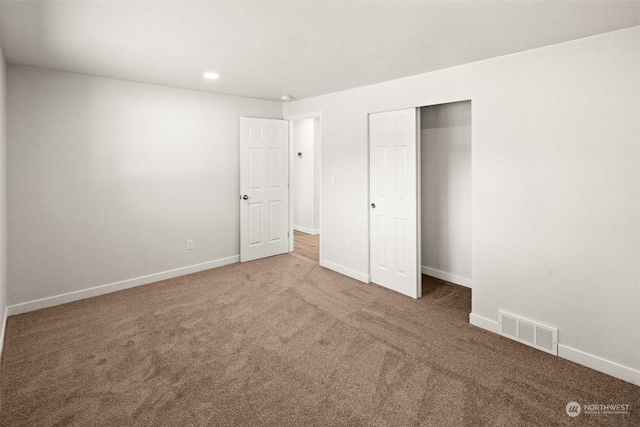 unfurnished bedroom with carpet floors and a closet