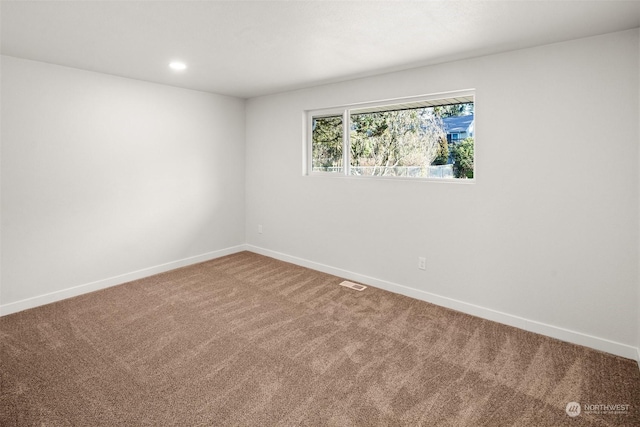 unfurnished room featuring carpet