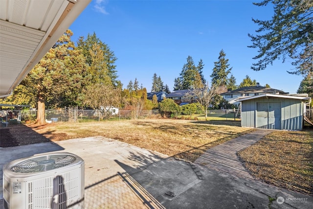 view of yard featuring a patio, central AC, and a storage unit