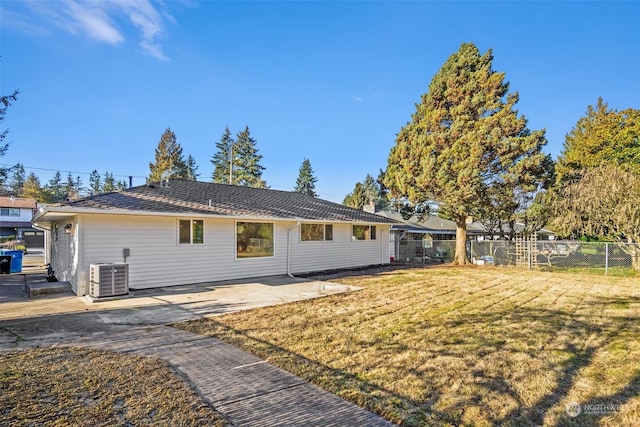 exterior space with a patio, a lawn, and central air condition unit