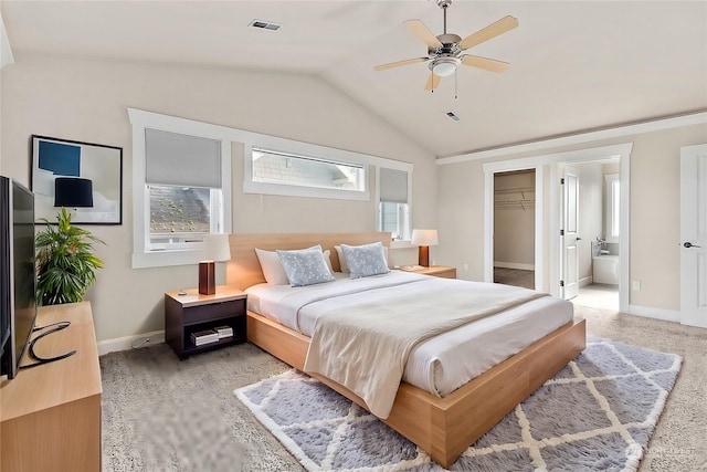 bedroom featuring ceiling fan, a closet, a walk in closet, and multiple windows