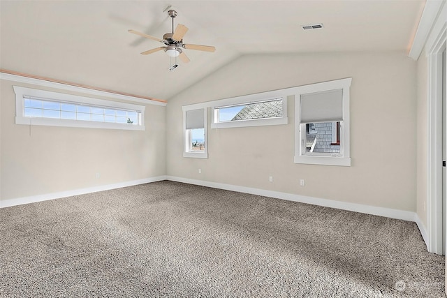 spare room featuring carpet, ceiling fan, and lofted ceiling