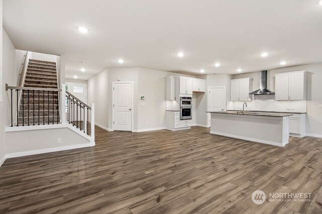 unfurnished living room with sink and dark hardwood / wood-style floors