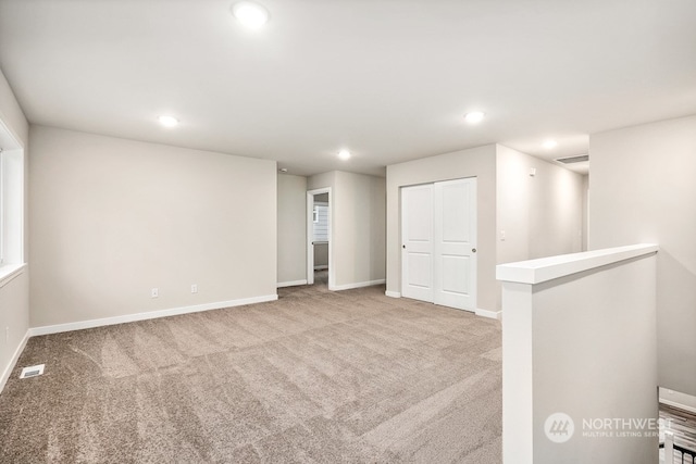 unfurnished room with light colored carpet