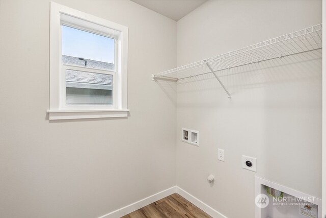 washroom with washer hookup, hardwood / wood-style flooring, electric dryer hookup, and gas dryer hookup