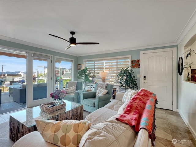 living room with light tile patterned floors, ceiling fan, and crown molding